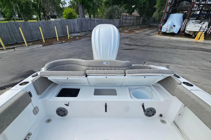 Slide: The Image of 2026 Sea Hunt Ultra 245 SE boat interior with seating and storage compartments. - 11