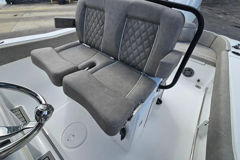 Slide: The Image of 2026 Sea Hunt Ultra 245 SE boat interior with plush gray seating and steering wheel. - 16