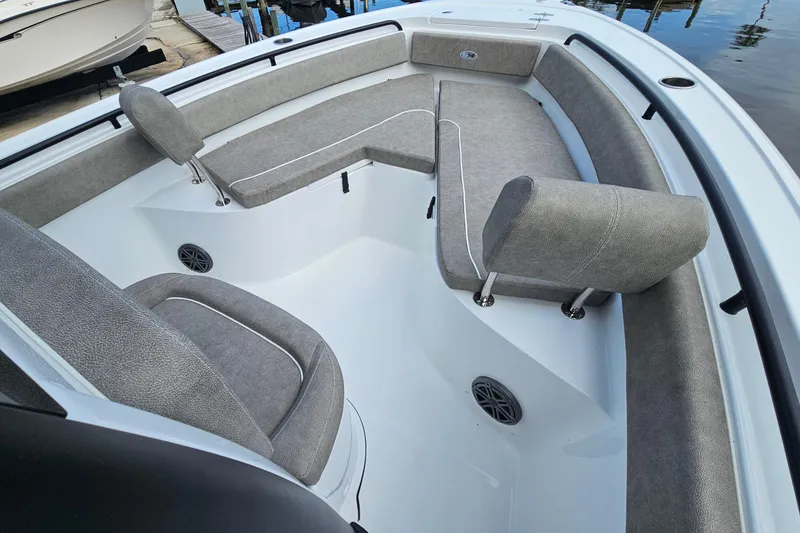 Slide: The Image of 2026 Sea Hunt Ultra 245 SE boat interior with gray cushioned seating and sleek design. - 21