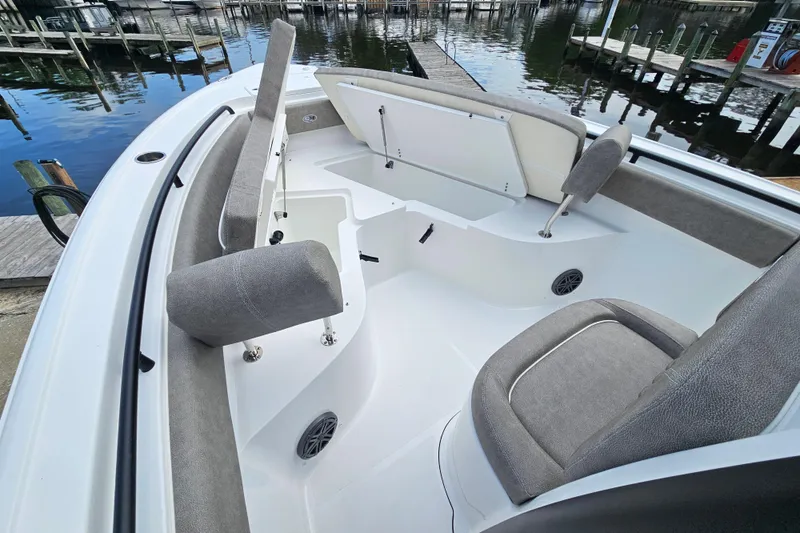 Slide: The Image of 2026 Sea Hunt Ultra 245 SE boat interior with cushioned seating and storage compartments. - 22
