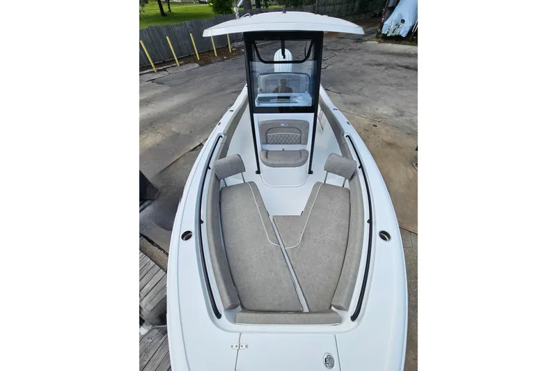 Slide: The Image of 2026 Sea Hunt Ultra 245 SE boat interior with cushioned seating and sleek design. - 23