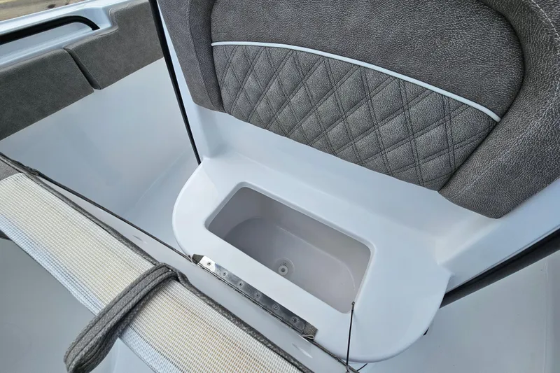 Slide: The Image of 2026 Sea Hunt Ultra 245 SE boat interior with quilted seating and storage compartment. - 25