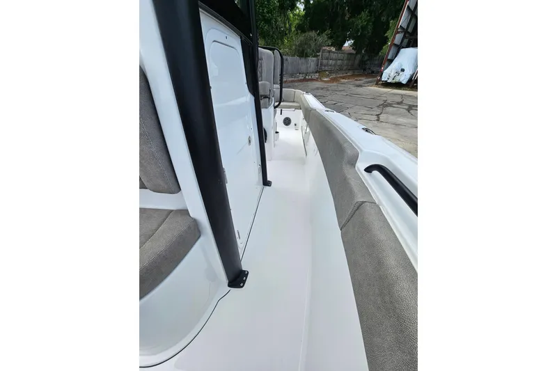 Slide: The Image of 2026 Sea Hunt Ultra 245 SE boat interior with cushioned seating and sleek design. - 26