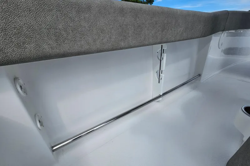 Slide: The Image of Interior view of 2026 Sea Hunt Ultra 245 SE boat, featuring sleek seating and storage. - 28