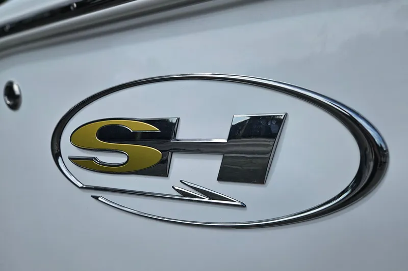 Slide: The Image of Logo of Sea Hunt Ultra 245 SE boat, model year 2026, with chrome and gold accents. - 3