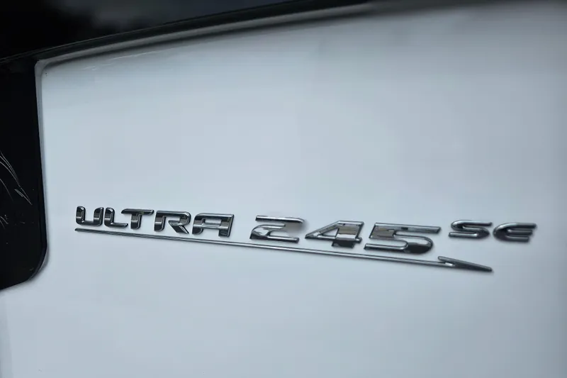 Slide: The Image of 2026 Sea Hunt Ultra 245 SE logo on white surface. - 30