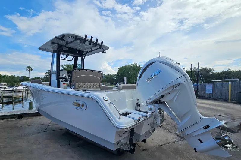 Slide: The Image of 2026 Sea Hunt Ultra 245 SE boat with Yamaha outboard motor docked outdoors. - 7