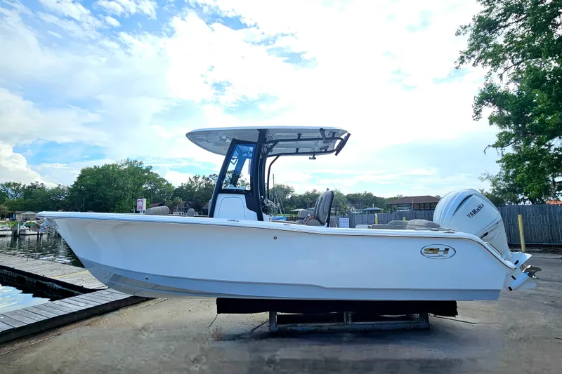 Slide: The Image of 2026 Sea Hunt Ultra 245 SE boat docked, featuring sleek design and Yamaha engine. - 8