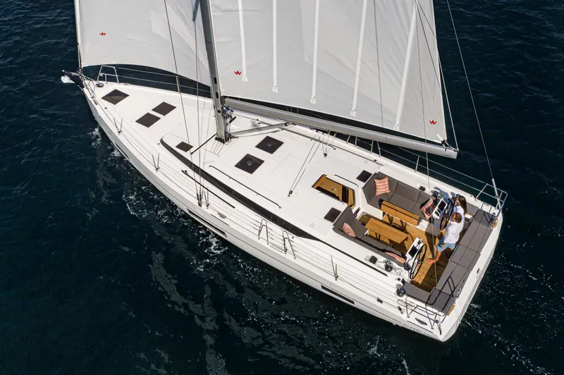 Slide: The Image of 2024 Bavaria C45 yacht sailing on open water, showcasing sleek design and spacious deck. - 10