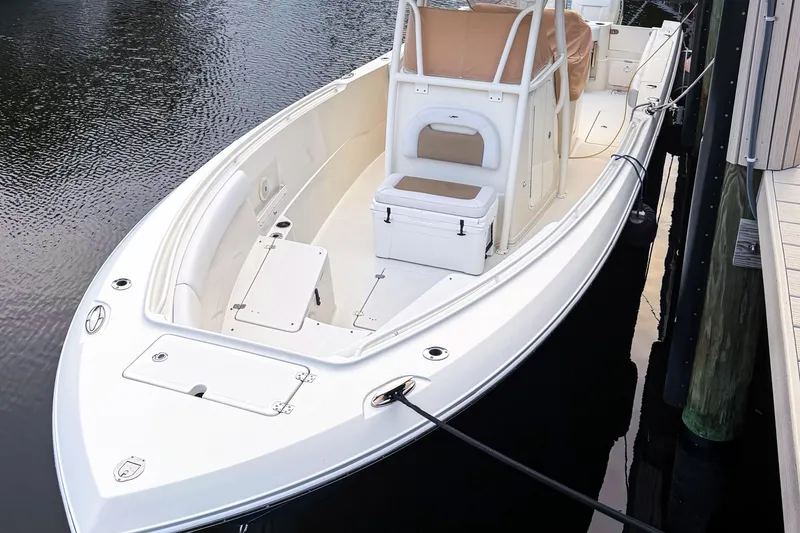 The Image of 2016 Sailfish 290 CC boat docked, featuring spacious deck and seating. - 0