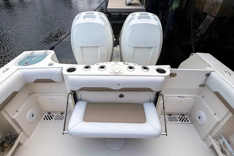 Slide: The Image of 2016 Sailfish 290 CC boat interior with dual engines and seating area. - 11