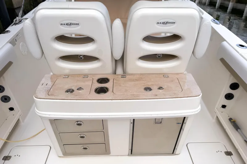 Slide: The Image of 2016 Sailfish 290 CC boat interior with dual seats and storage compartments. - 15