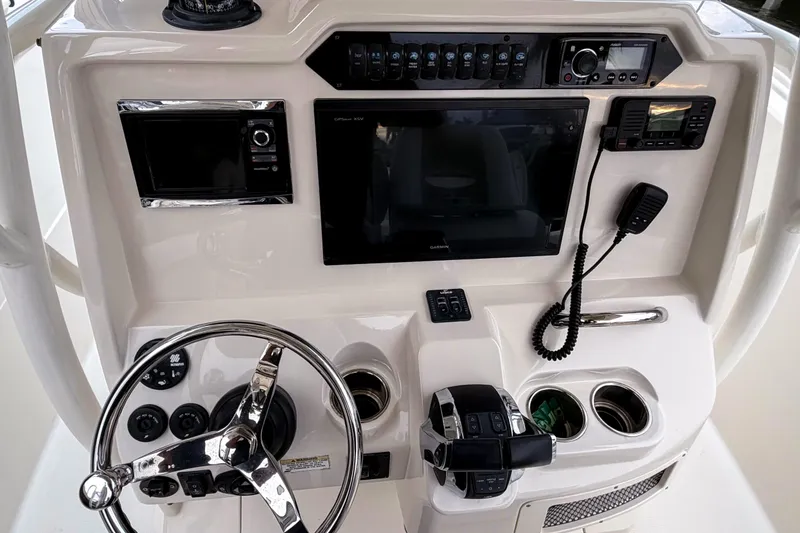 Slide: The Image of Control panel of a 2016 Sailfish 290 CC boat with steering wheel and electronics. - 17
