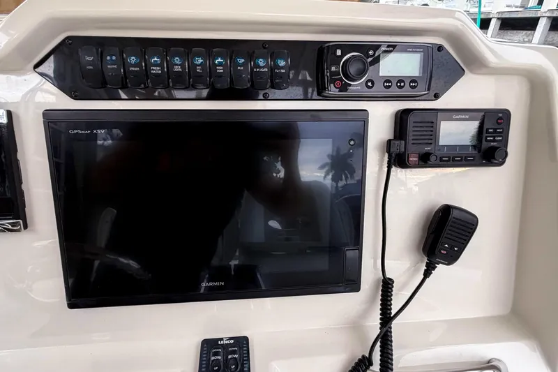 Slide: The Image of Control panel of 2016 Sailfish 290 CC boat with Garmin GPS and radio systems. - 18