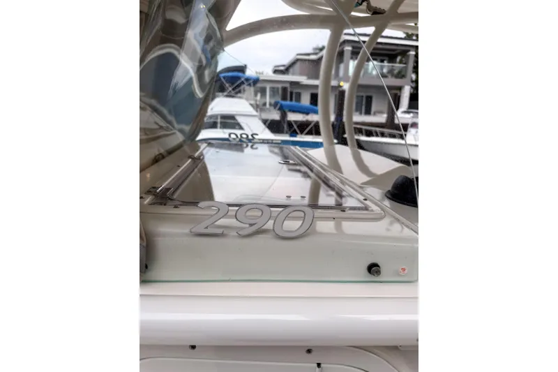 Slide: The Image of 2016 Sailfish 290 CC boat detail with visible model number at marina. - 22
