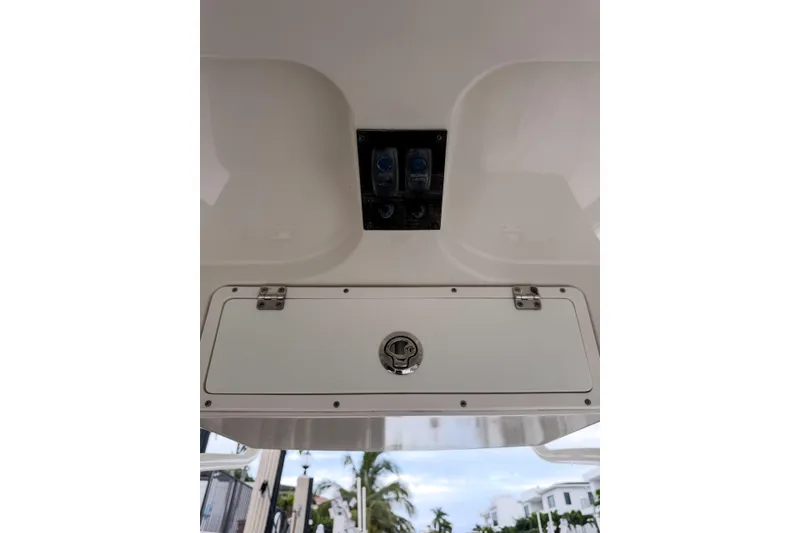Slide: The Image of 2016 Sailfish 290 CC boat console with storage compartment and control panel. - 25