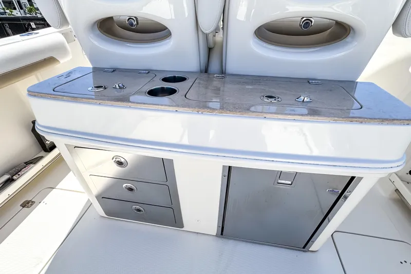 Slide: The Image of 2016 Sailfish 290 CC boat interior with storage drawers and countertop. - 29