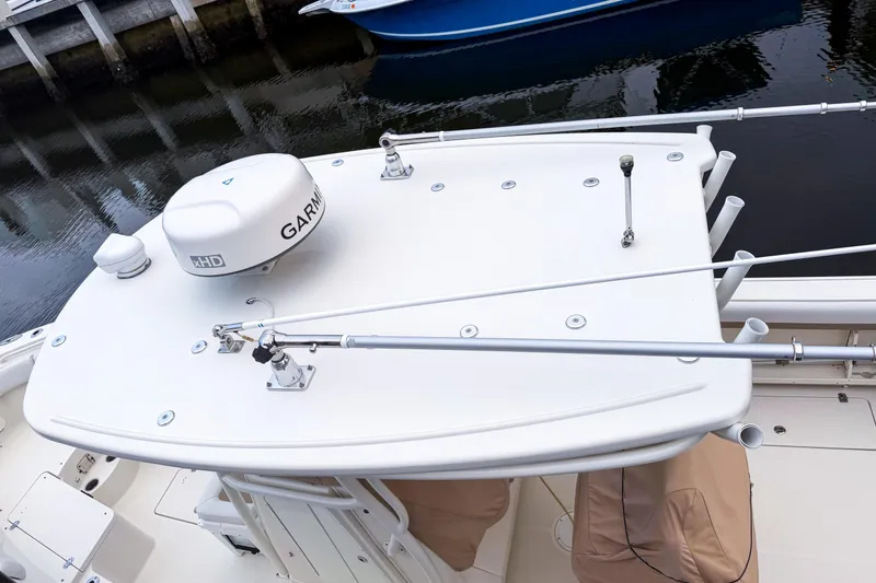 Slide: The Image of 2016 Sailfish 290 CC boat with Garmin radar, docked by the water. - 3