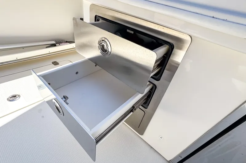 Slide: The Image of Open storage compartment on 2016 Sailfish 290 CC boat, showcasing sleek design and functionality. - 31