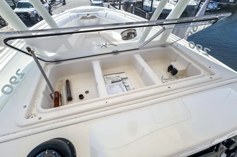 Slide: The Image of Open storage compartment on a 2016 Sailfish 290 CC boat, dockside view. - 40