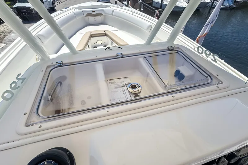 Slide: The Image of 2016 Sailfish 290 CC boat deck with storage compartment and seating area. - 41