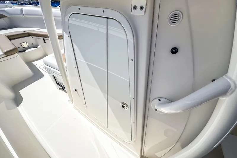 Slide: The Image of 2016 Sailfish 290 CC boat interior with seating and storage compartment. - 44