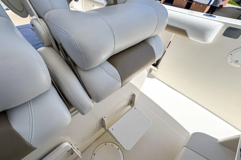 Slide: The Image of 2016 Sailfish 290 CC boat interior with cushioned seating and storage compartments. - 45