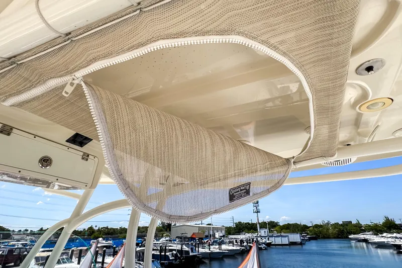 Slide: The Image of 2016 Sailfish 290 CC boat with custom marine storage, docked at a marina. - 46