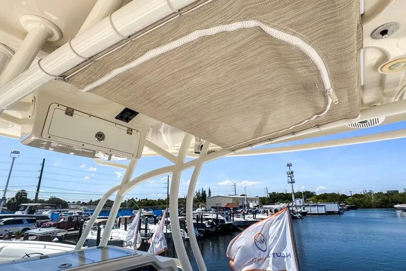 Slide: The Image of 2016 Sailfish 290 CC boat interior view at marina with storage compartment. - 47