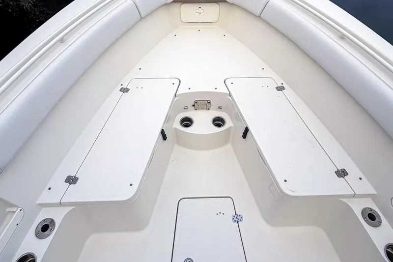 Slide: The Image of 2016 Sailfish 290 CC boat interior, featuring spacious seating and storage compartments. - 5