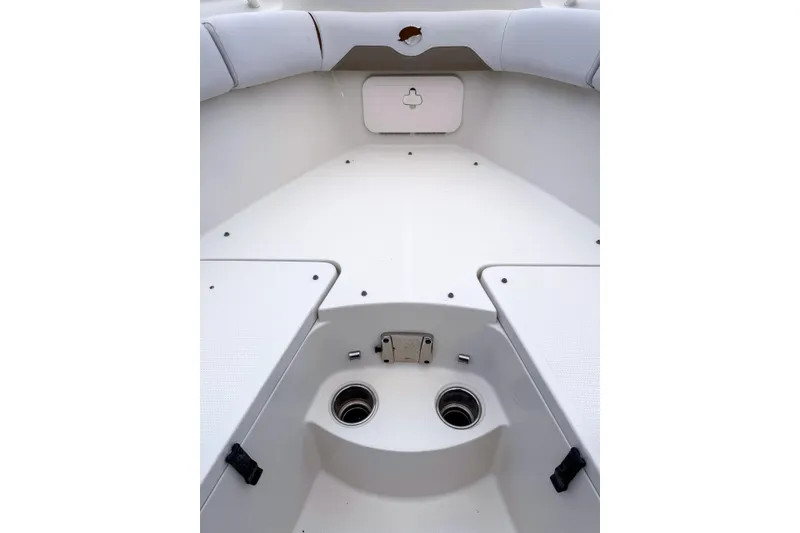 Slide: The Image of Interior view of a 2016 Sailfish 290 CC boat, showcasing seating and storage compartments. - 6