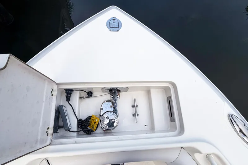 Slide: The Image of 2016 Sailfish 290 CC boat anchor compartment with open hatch and equipment. - 7