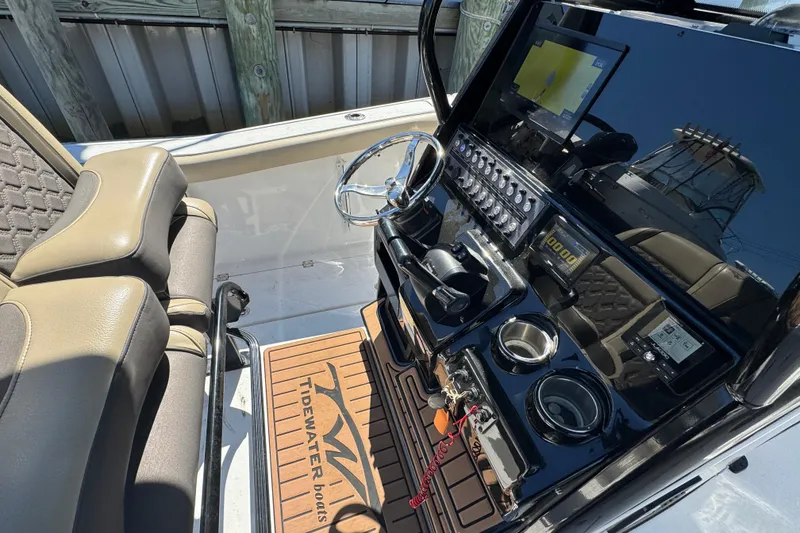 Slide: The Image of 2022 Tidewater 256 CC Adventure boat console with steering wheel and navigation display. - 14