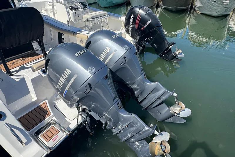 Slide: The Image of 2022 Tidewater 256 CC Adventure boat with Yamaha and Mercury outboard engines. - 2