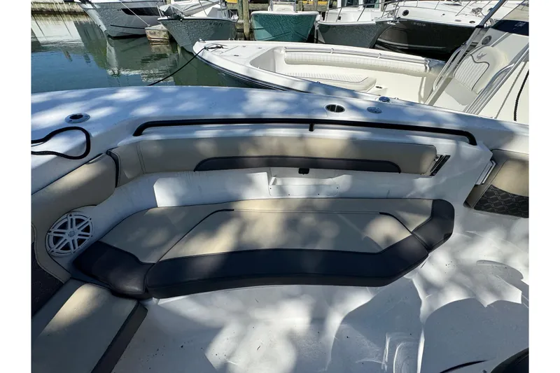 Slide: The Image of 2022 Tidewater 256 CC Adventure boat interior with cushioned seating and speaker. - 21