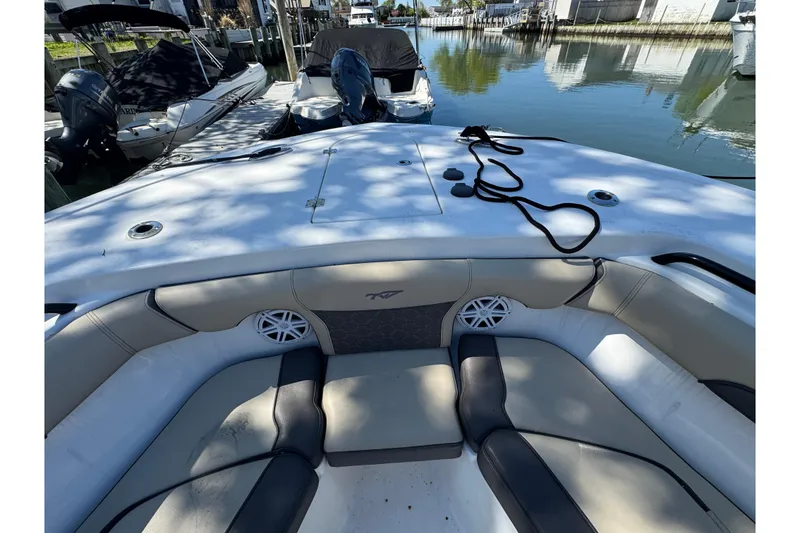 Slide: The Image of 2022 Tidewater 256 CC Adventure boat interior with seating and speakers. - 22