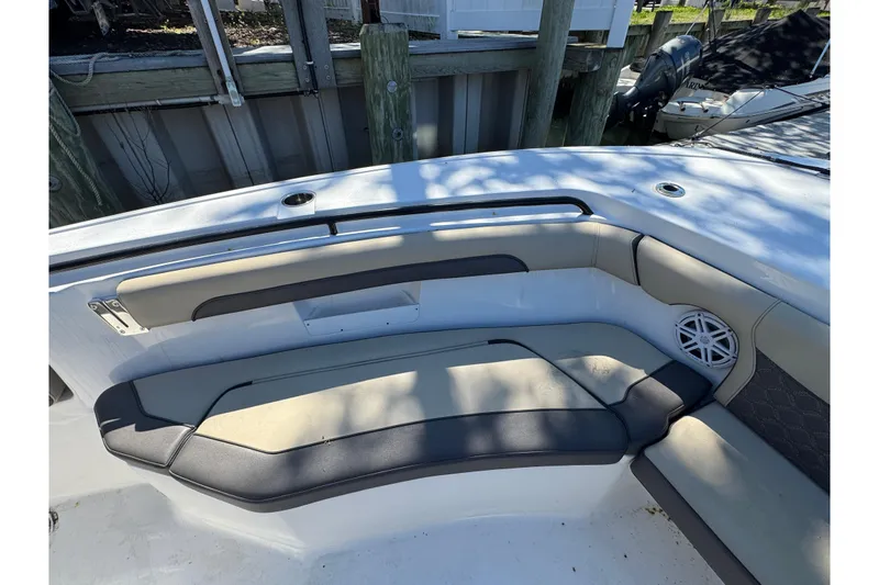 Slide: The Image of 2022 Tidewater 256 CC Adventure boat interior with cushioned seating and speaker. - 23