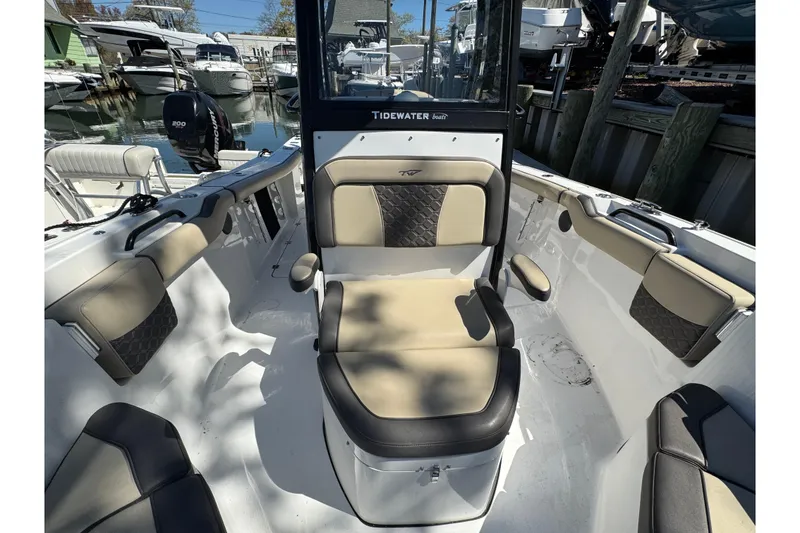 Slide: The Image of 2022 Tidewater 256 CC Adventure boat interior with cushioned seating and modern design. - 24