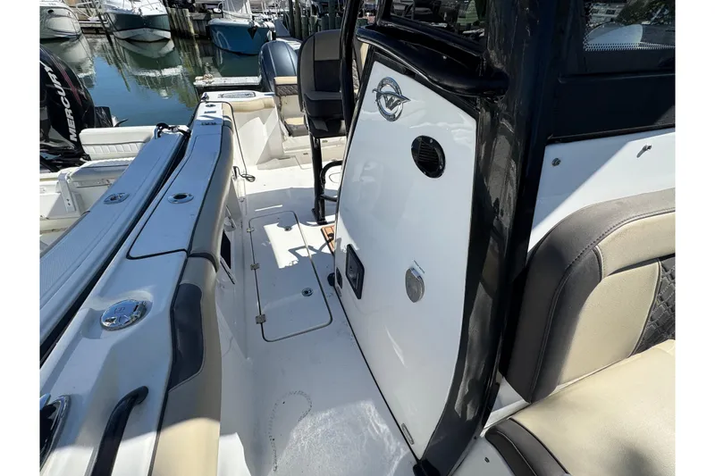 Slide: The Image of 2022 Tidewater 256 CC Adventure boat interior with seating and deck details. - 26