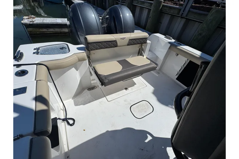 Slide: The Image of 2022 Tidewater 256 CC Adventure boat interior with seating and dual engines. - 28
