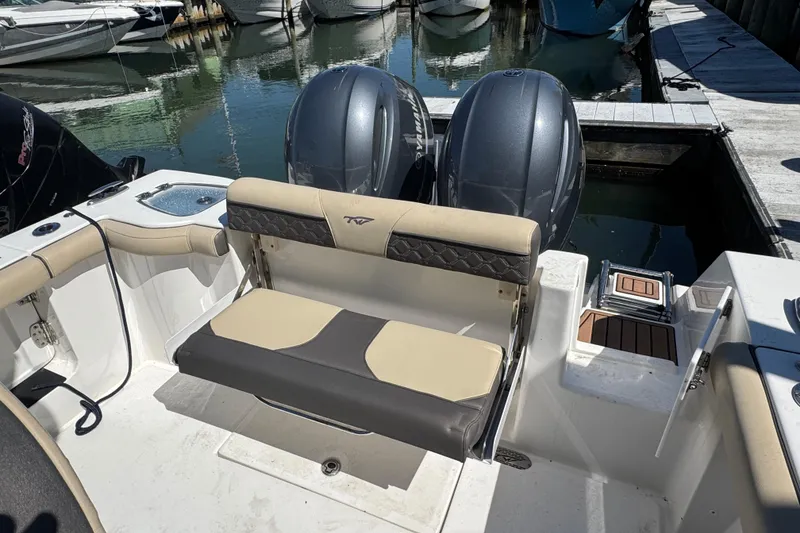 Slide: The Image of 2022 Tidewater 256 CC Adventure boat with dual engines docked at marina. - 3
