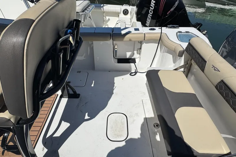 Slide: The Image of 2022 Tidewater 256 CC Adventure boat interior with seating and Mercury engine. - 4
