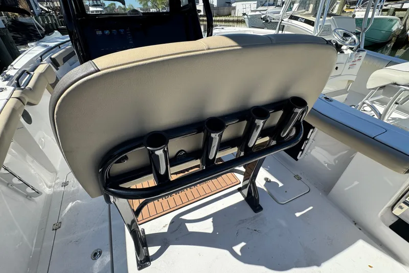 Slide: The Image of 2022 Tidewater 256 CC Adventure boat interior with rod holders and seating. - 5