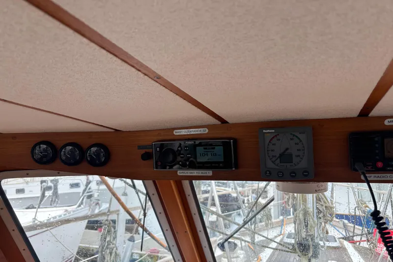 Slide: The Image of Interior view of a 2001 Nauticat Staysail Ketch cockpit with navigation instruments. - 11