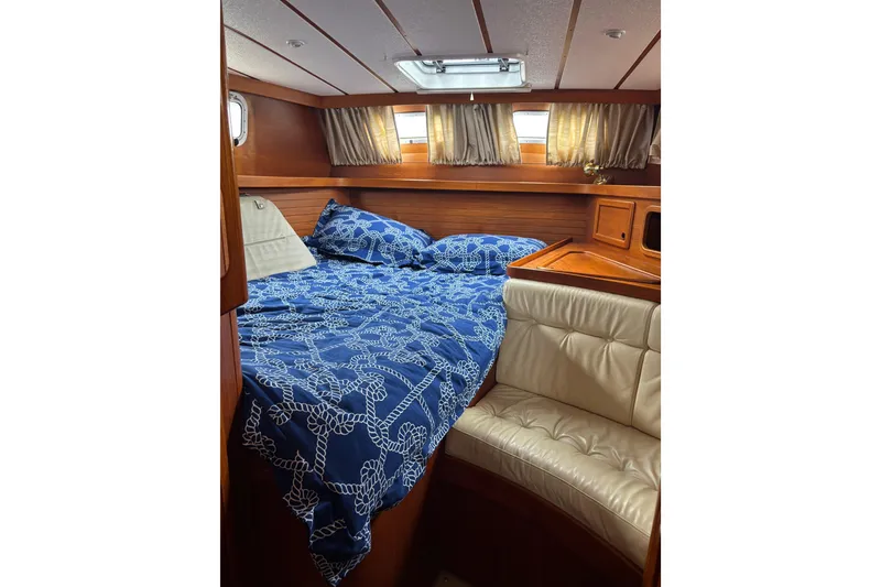 Slide: The Image of Interior of a 2001 Nauticat Staysail Ketch with cozy bed and seating area. - 15