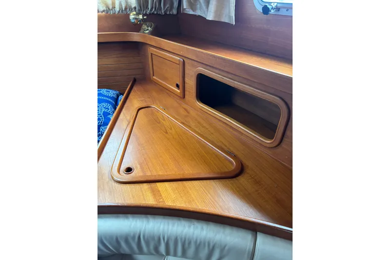Slide: The Image of Interior of 2001 Nauticat Staysail Ketch, featuring wooden cabinetry and storage compartments. - 16