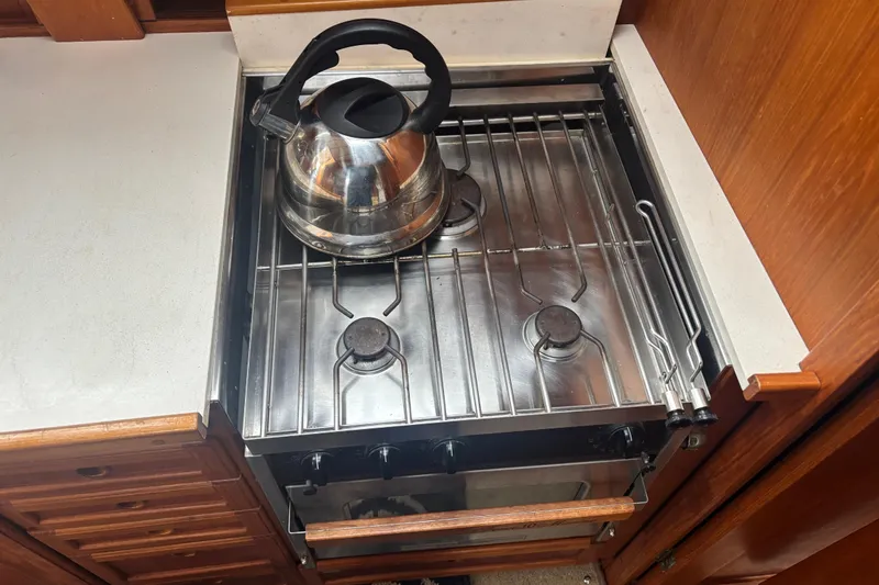 Slide: The Image of Stainless steel stove with kettle in 2001 Nauticat Staysail Ketch yacht kitchen. - 18