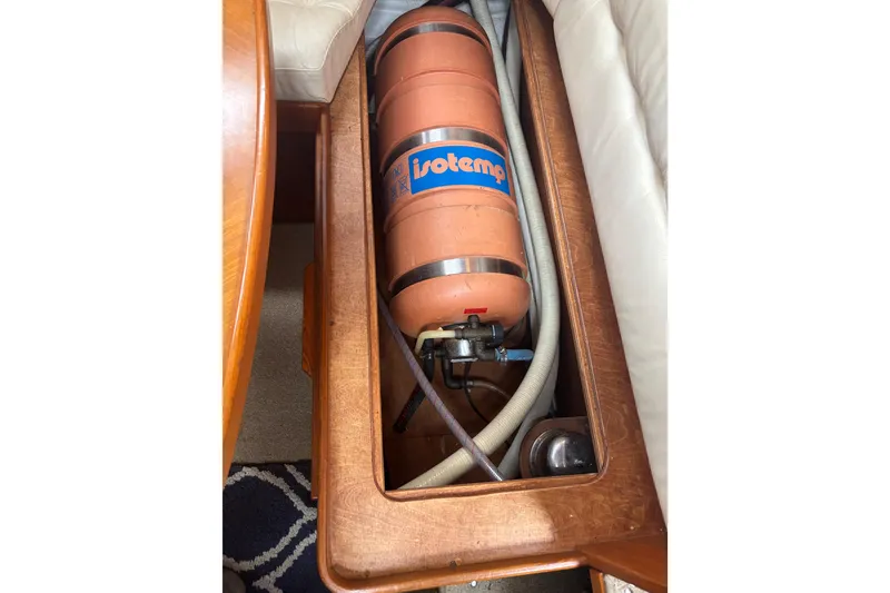 Slide: The Image of Nauticat Staysail Ketch 2001 interior with Isotemp water heater in wooden compartment. - 24