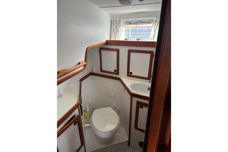Slide: The Image of Interior of 2001 Nauticat Staysail Ketch bathroom with wooden accents and compact design. - 26