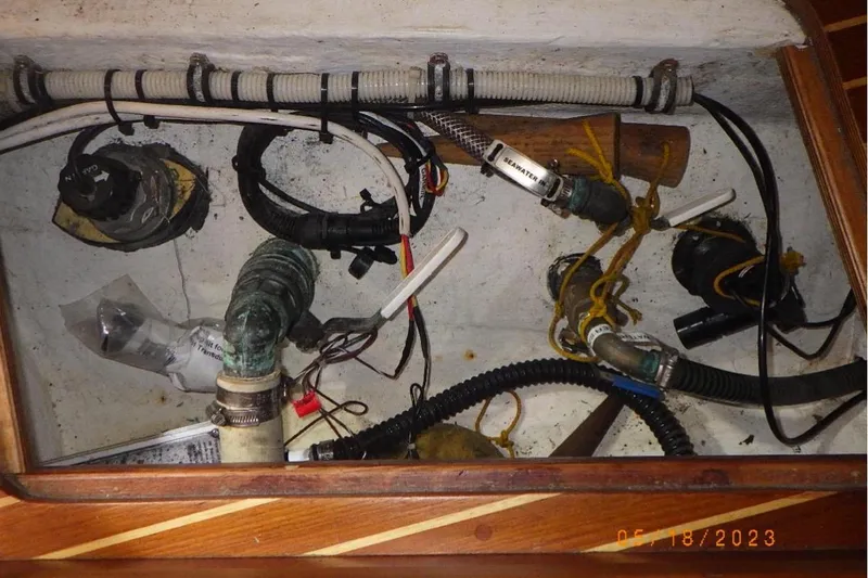 Slide: The Image of Interior view of 2001 Nauticat Staysail Ketch showing wiring and plumbing components. - 27